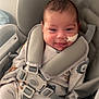 baby, infant, child, car_seat, harness, safety_strap, onesie, smile, face, head, newborn, pajamas, medical_tape, buckle, padding, cozy, indoor, portrait, seat, happy