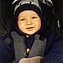 baby, child, smiling, hat, knitwear, blue, car_seat, straps, warm_clothing, happy, infant, cute, portrait, face, person, winter, bundle, closeup, seatbelt, cozy