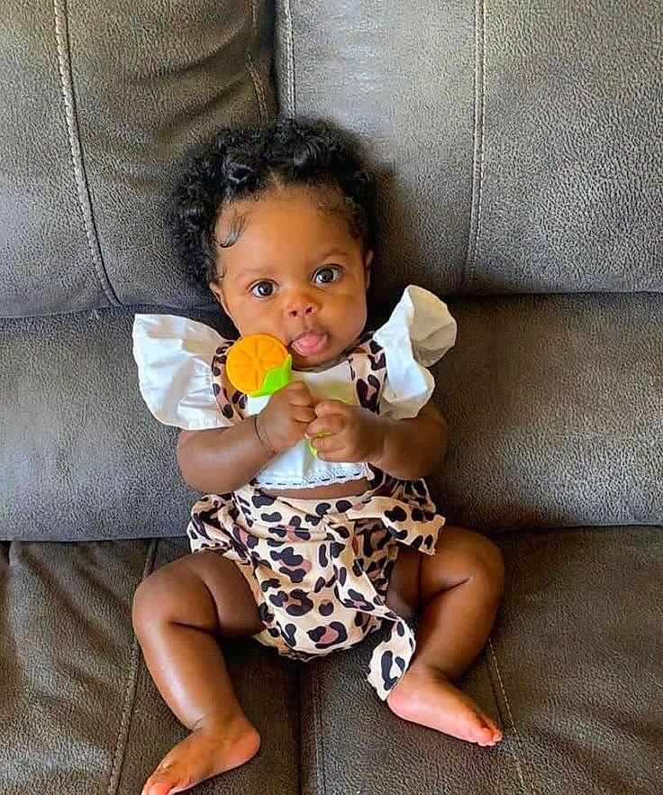 Miyah is registered to the contest to win money with this photo: baby, baby_toddler_clothing, beauty, blond, cheek, child, comfort, couch, dress, eye, hair, happy, iris, lip, mouth, nose, person, sitting, skin, thigh