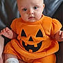 baby, blue_eyes, child, chubby_cheeks, costume, cute, face, green, halloween, hat, holiday, indoor, infant, leather_couch, orange, portrait, pumpkin_costume, sitting, socks, soft