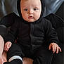 baby, bat_costume, black_clothing, child, costume, couch, cute, face, fingers, footwear, front_view, indoors, infant, looking_at_camera, person, plush, sitting, soft_texture, wide_eyes, young_child