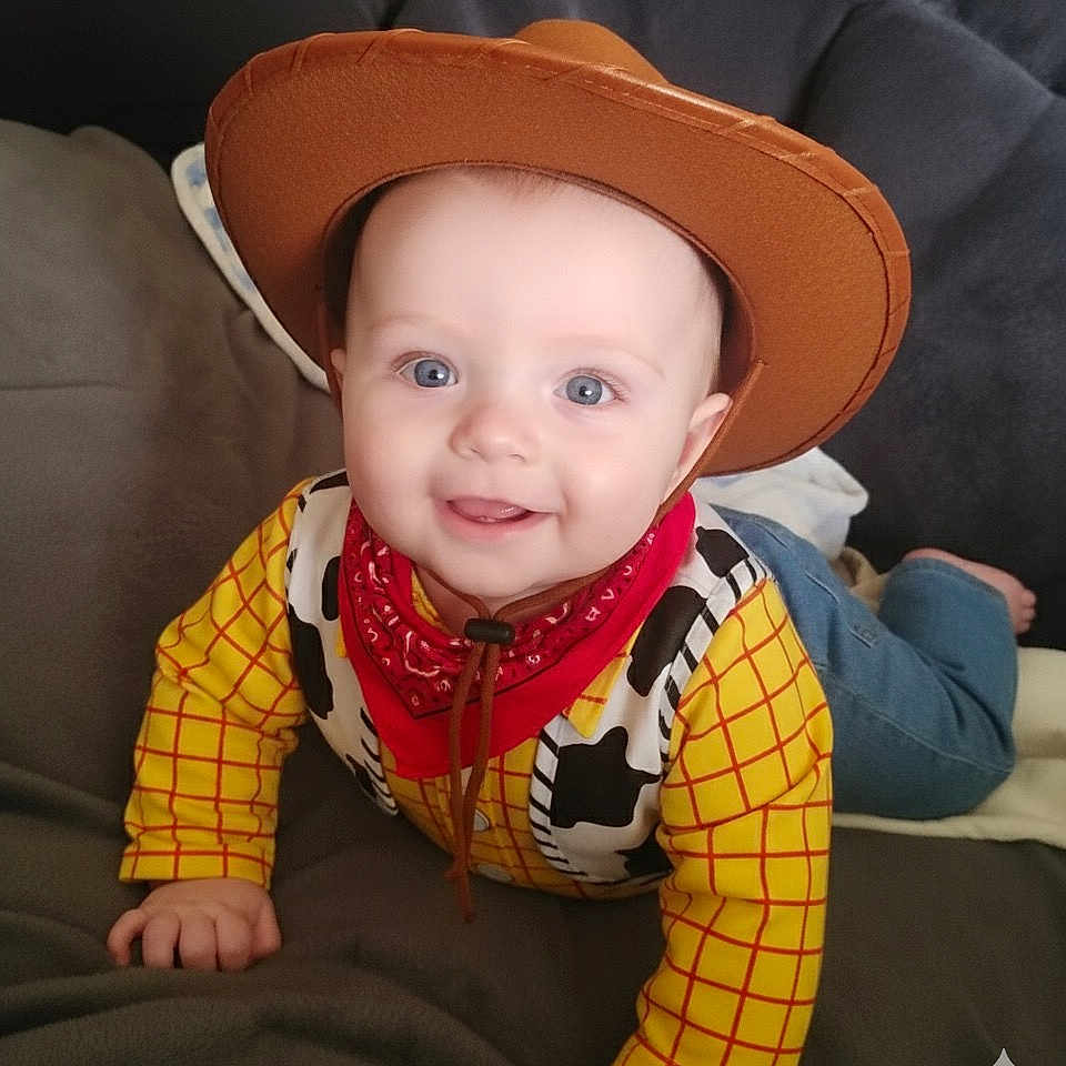Lennie-Jax joined the competition — help win amazing prizes! baby, blue_jeans, child, clothing, costume, couch, cowboy, cute, face, feet, hand, happy, hat, indoor, infant, person, portrait, red_bandana, smiling, yellow_shirt