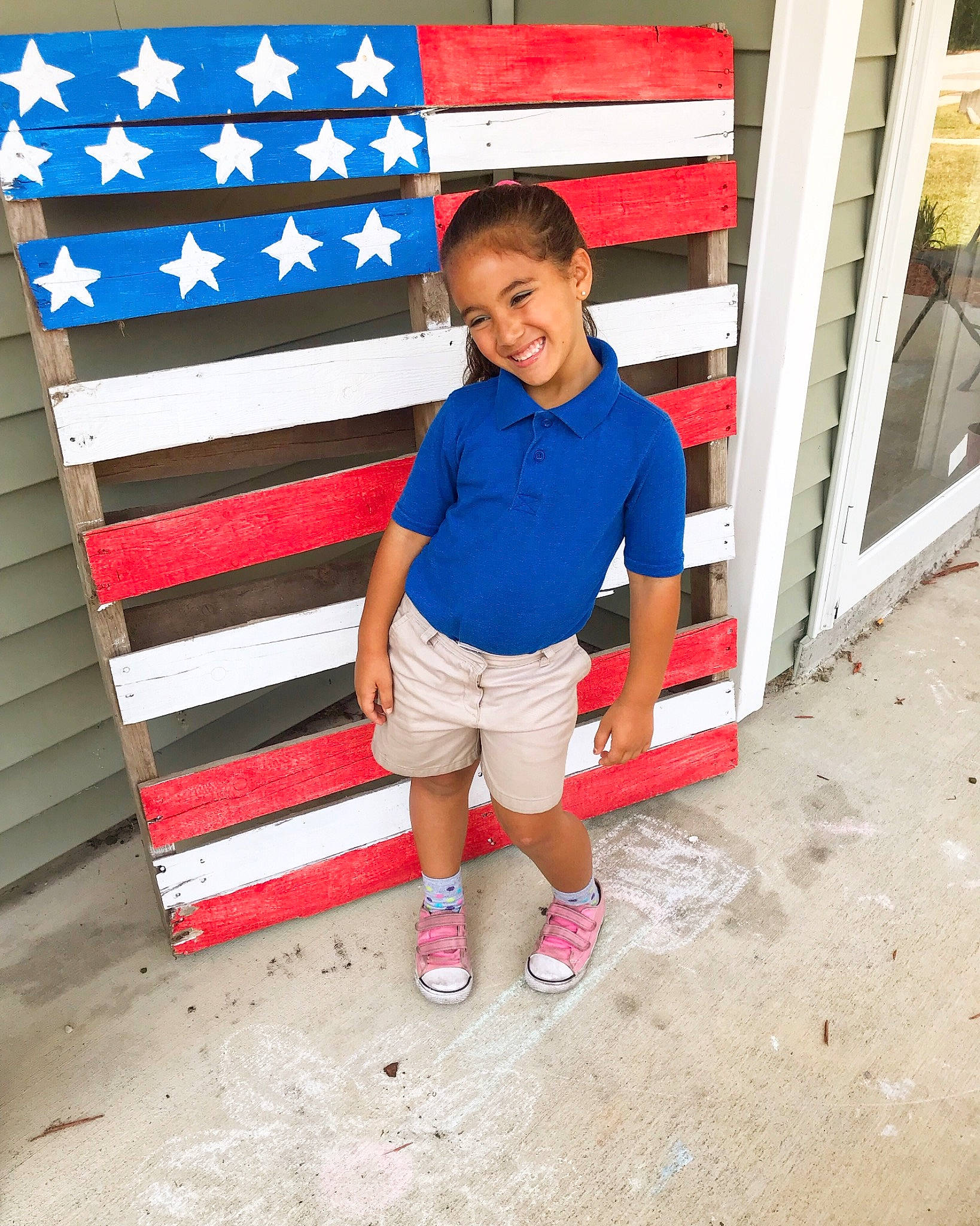 Katelyhn is registered to the contest to win money with this photo: blue, child, flag, fun, joy, male, person, play, red, shoe, shorts, sleeve, smile, standing, summer, t_shirt, textile, toddler, vacation, world