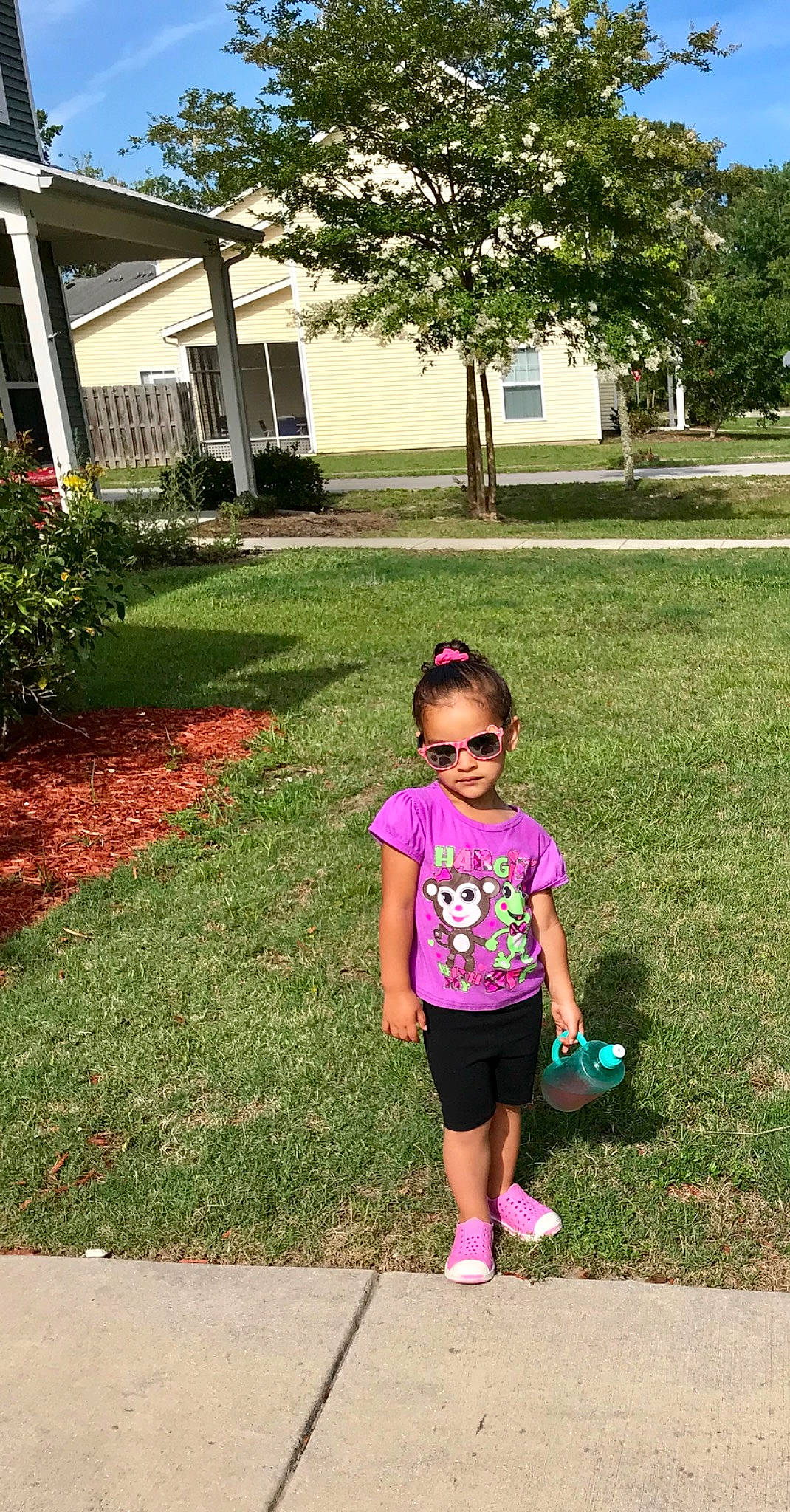 Ali is registered to the contest to win money with this photo: child, fun, garden, grass, lawn, leisure, magenta, person, pink, plant, play, recreation, shorts, shoulder, smile, summer, toddler, tree, vacation, walking