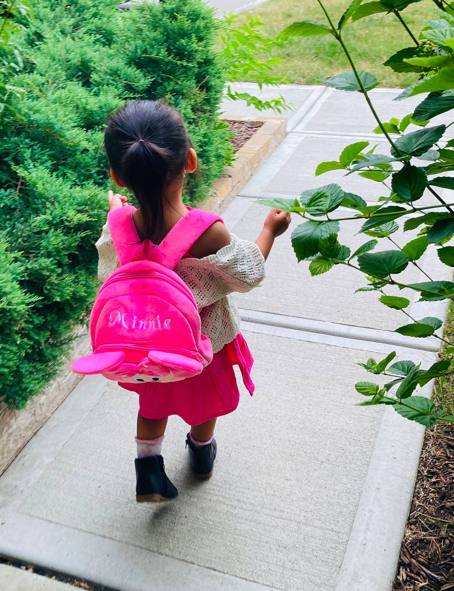 Hannah joined the competition — help win amazing prizes! baby_toddler_clothing, child, fun, garden, gesture, grass, leisure, magenta, pattern, person, plant, play, sandal, shrub, sidewalk, sitting, toddler, tree, vacation, walking