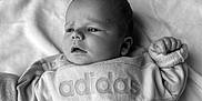 Eliot participe au concours pour gagner de l'argent avec cette photo : adidas, baby, black_and_white, blanket, closeup, clothing, cozy, cute, expression, face, hand, indoor, infant, lying_down, newborn, person, portrait, soft, sweatshirt, young_child