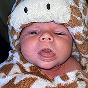 Eliot participe au concours pour gagner de l'argent avec cette photo : baby, brown, child, closeup, cute, expression, face, giraffe_pattern, headwear, hooded_towel, indoors, infant, mouth_open, person, portrait, skin, soft_texture, towel, white, wrapped