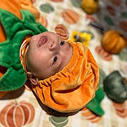 Nicolas is registered to the contest to win money with this photo: ammunition, baby, babylaughing, blanket, face, grenade, happy, head, person, photography, portrait, smile, weapon, yawning