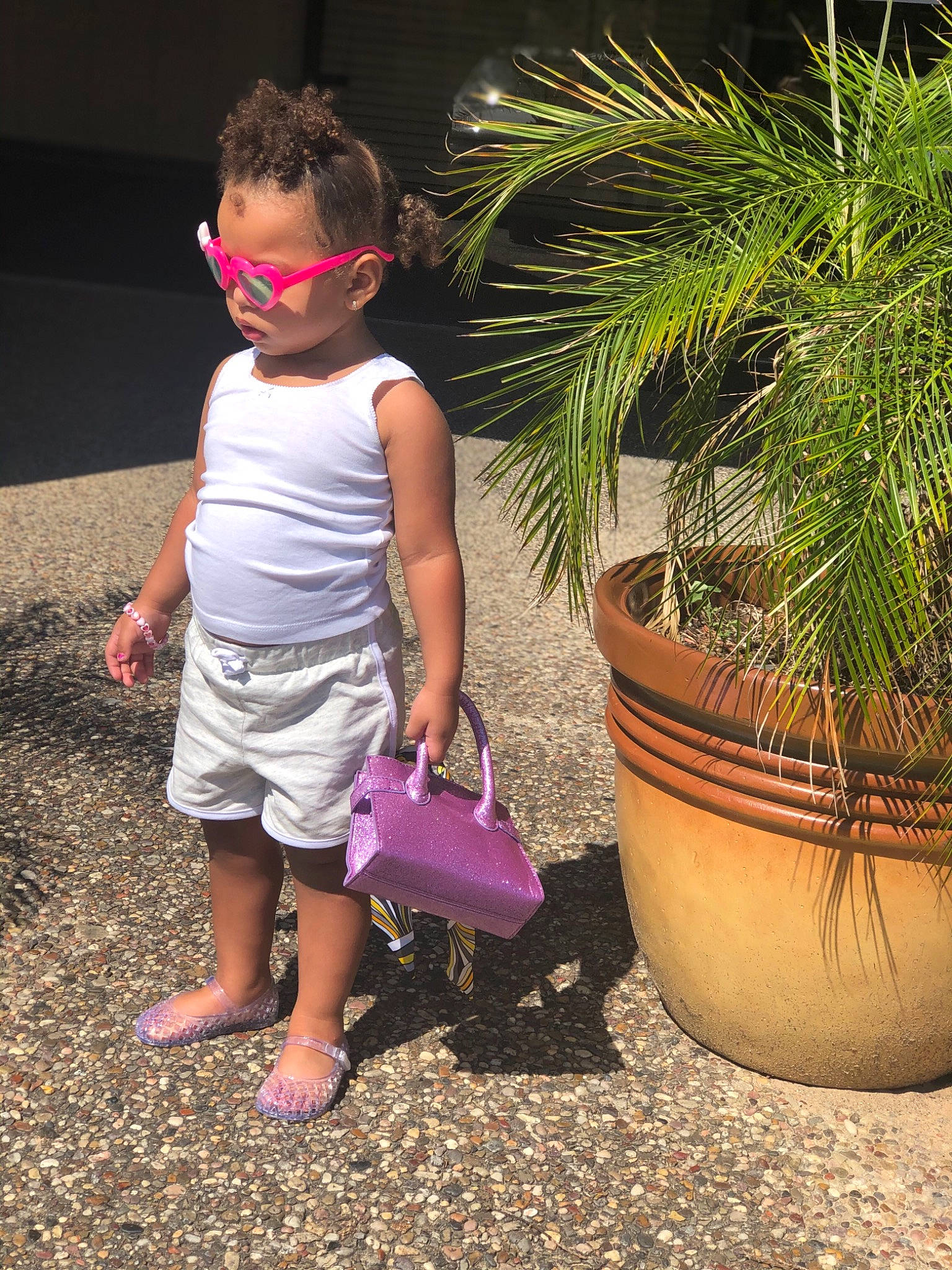 Camari is registered to the contest to win money with this photo: botany, child, flower, grass, grass_family, leaf, leg, person, pink, plant, play, shoe, smile, summer, toddler, tree, vacation, water