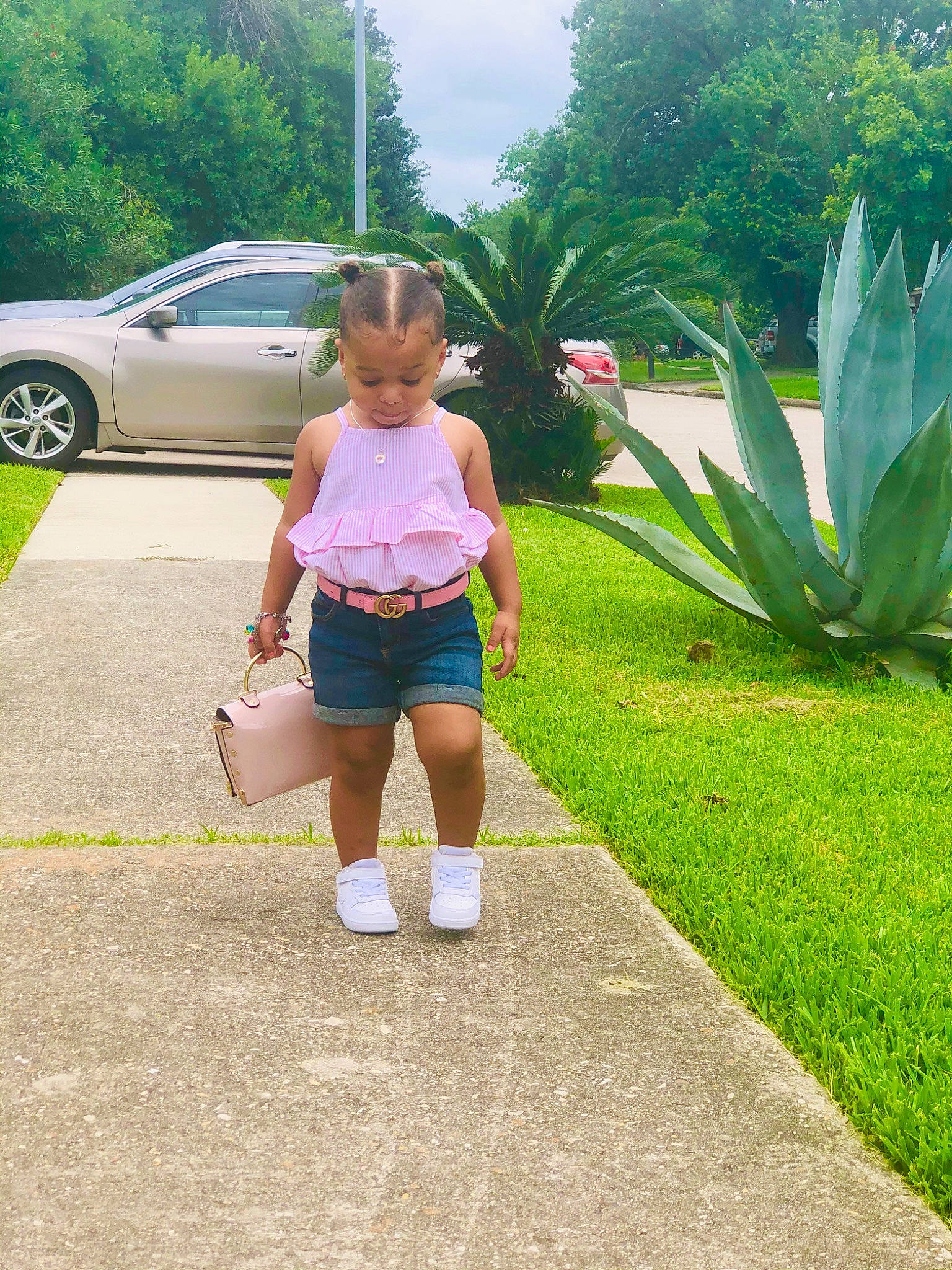 Camari is registered to the contest to win money with this photo: botany, car, child, family_car, footwear, garden, grass, leisure, luxury_vehicle, minivan, person, pink, plant, recreation, shorts, summer, tree, vacation, vehicle, vehicle_door