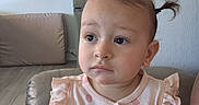 Ameerah joined the competition — help win amazing prizes! baby, brush, child, couch, eyes, face, furniture, hair, home, indoors, living_room, looking_away, photography, pigtails, pink_outfit, portrait, romper, sitting, smiling, toddler