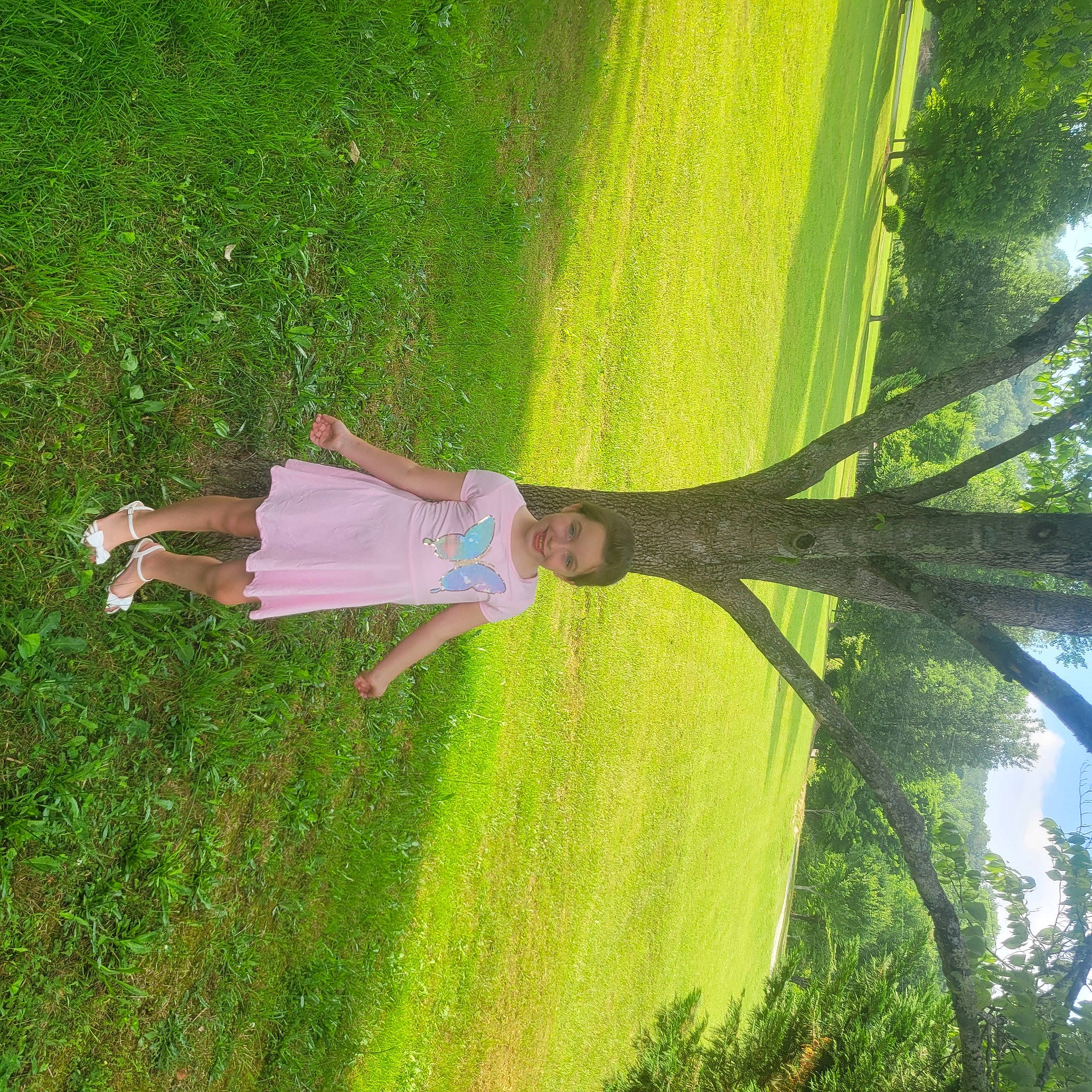 Isabella is registered to the contest to win money with this photo: botany, grass, grass_family, groundcover, joy, landscape, lawn, leaf, leisure, nature, people_in_nature, person, plant, shrub, smile, sunlight, terrestrial_plant, tints_and_shades, tree, trunk