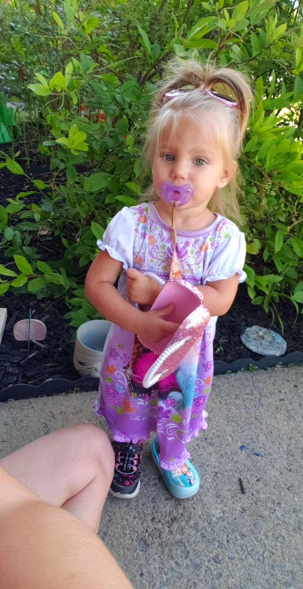 Oaklynn is registered to the contest to win money with this photo: baby_toddler_clothing, blond, child, cool, eye, face, fun, grass, grass_family, hair, head, leaf, pattern, person, pink, plant, shoe, skin, sock, thumb