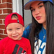 Jayden joined the competition — help win amazing prizes! child, toddler, woman, smiling, red_shirt, blue_shirt, cap, backwards_cap, adidas, brick_wall, door, portrait, outdoor, people, casual, happy, face, long_hair, cross_necklace, hand