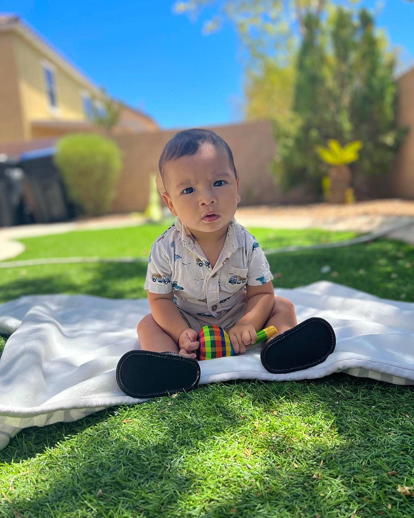Gael is registered to the contest to win money with this photo: baby, baby_toddler_clothing, child, flooring, fun, grass, grassland, happy, lawn, leisure, people_in_nature, person, plant, recreation, shorts, sitting, sky, t_shirt, tints_and_shades, toddler