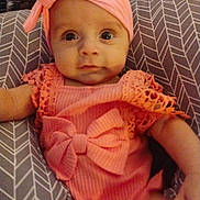 Rose joined the competition — help win amazing prizes! baby, infant, pink_outfit, headband, cushion, patterned_cushion, cute, portrait, child, smile, indoors, person, young_child, baby_girl, clothing, face, eyes, arm, headwear, resting