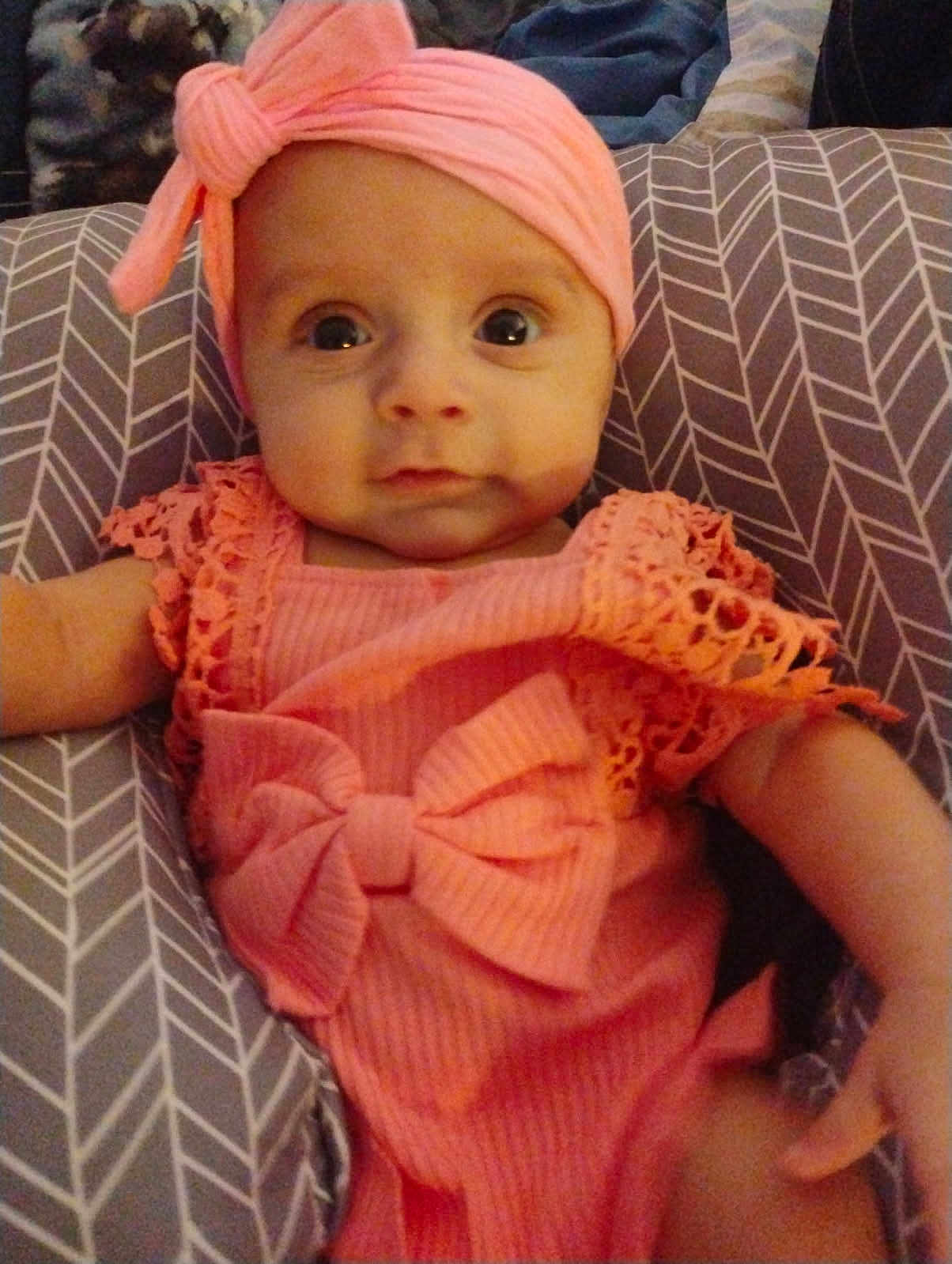 Rose joined the competition — help win amazing prizes! baby, infant, pink_outfit, headband, cushion, patterned_cushion, cute, portrait, child, smile, indoors, person, young_child, baby_girl, clothing, face, eyes, arm, headwear, resting