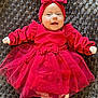élya participe au concours pour gagner de l'argent avec cette photo : adorable, baby, blanket, celebration, child, closeup, cute, fashion, happy, headband, heart_pattern, indoors, infant, lying_down, portrait, red_dress, smiling, soft_texture, tulle_skirt, white_tights