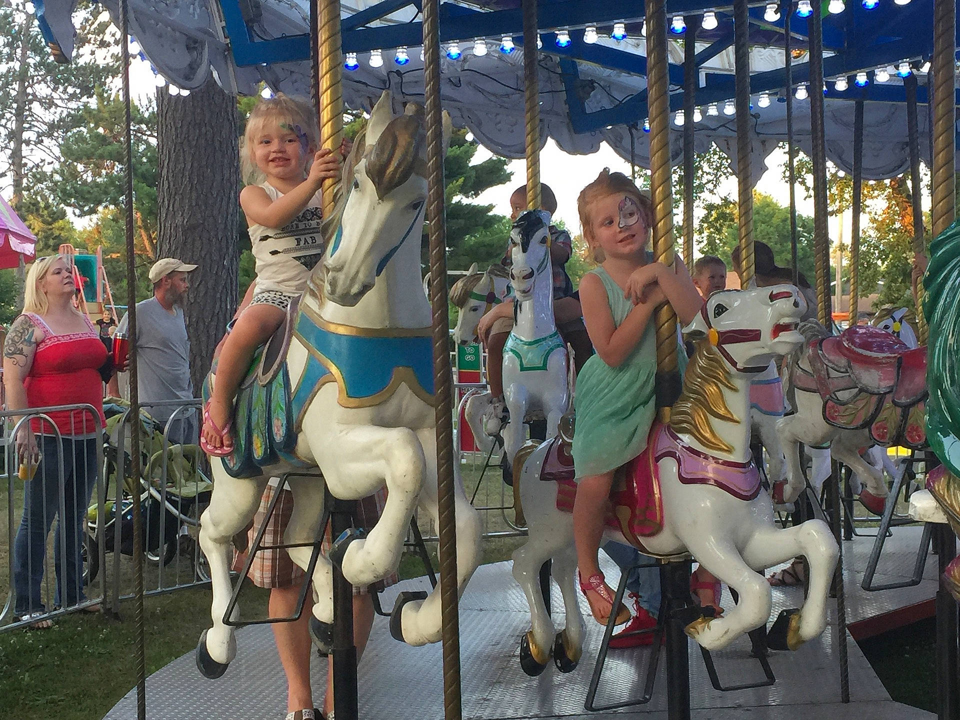Madelynn joined the competition — help win amazing prizes! amusement_park, amusement_ride, carousel, fair, fun, joy, leisure, outdoor_recreation, park, person, recreation, tree
