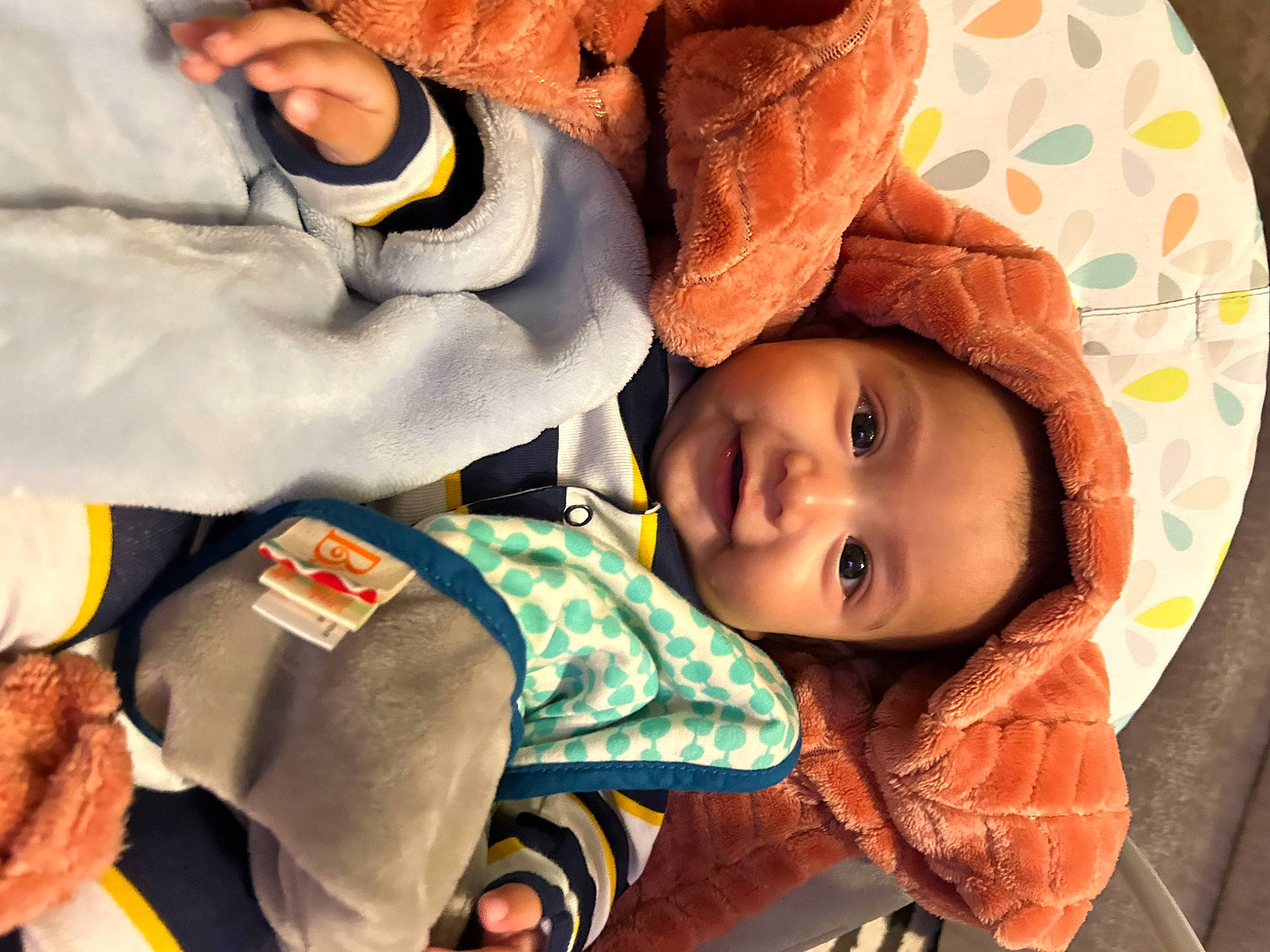 Kaedo is registered to the contest to win money with this photo: baby, baby_toddler_clothing, carmine, child, comfort, finger, fun, gesture, happy, head, headwear, joy, linens, mouth, nose, orange, person, product, room, smile