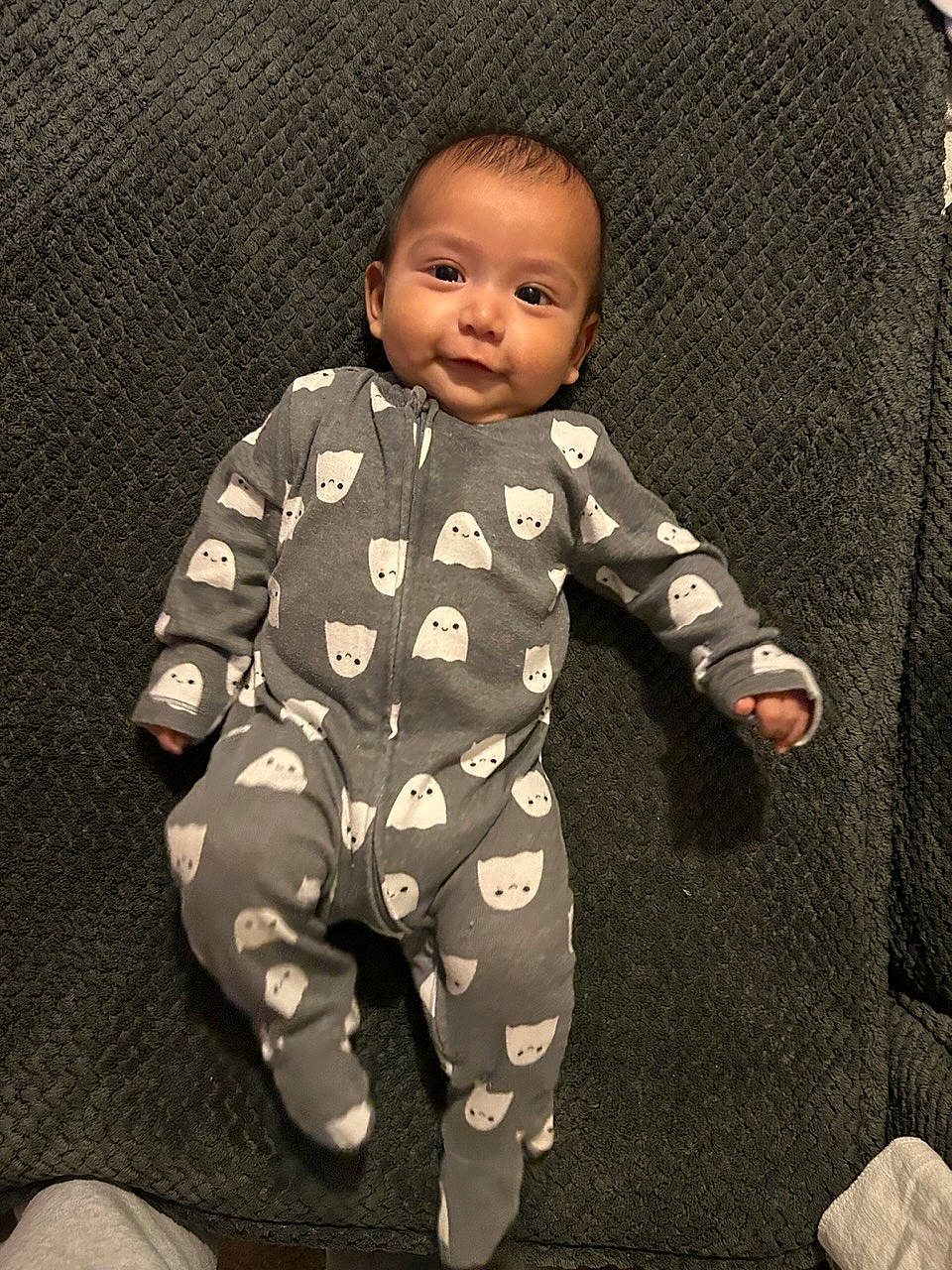 Kaedo is registered to the contest to win money with this photo: baby, baby_toddler_clothing, baby_toys, child, collar, comfort, flooring, knee, long_sleeved_t_shirt, nightwear, pajamas, pattern, person, personal_protective_equipment, room, sitting, sleeve, smile, toddler