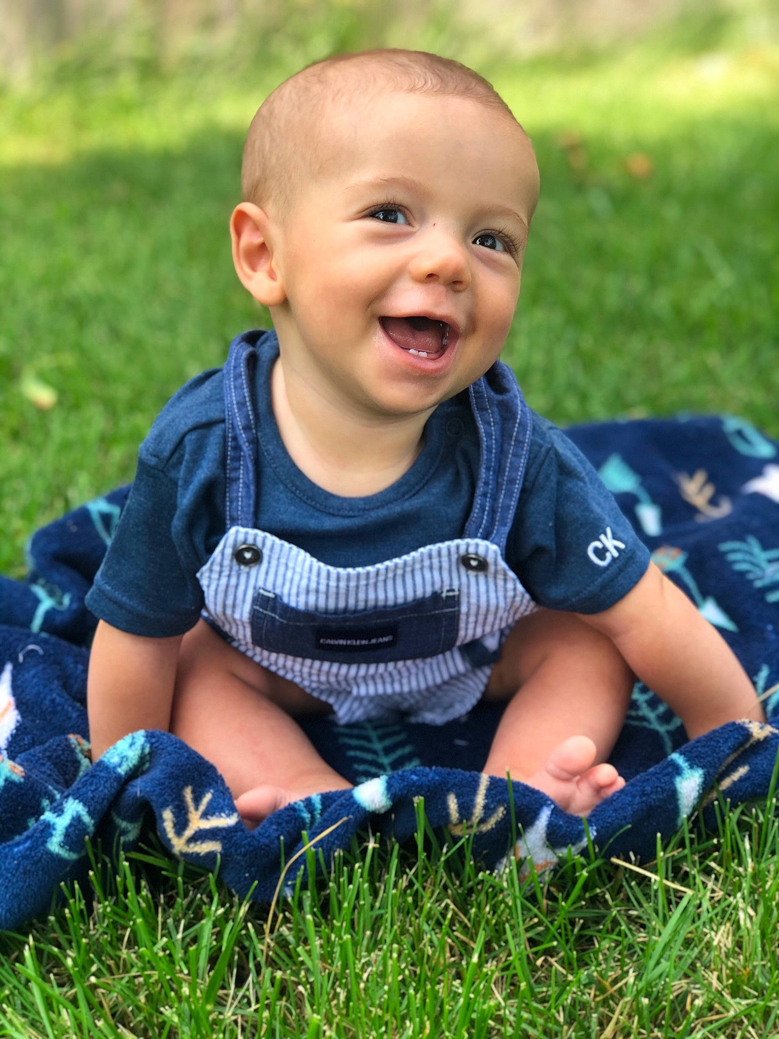 Bennington is registered to the contest to win money with this photo: baby, blue, cheek, child, cool, facial_expression, grass, grass_family, happy, laugh, lawn, person, photography, plant, play, sitting, smile, toddler