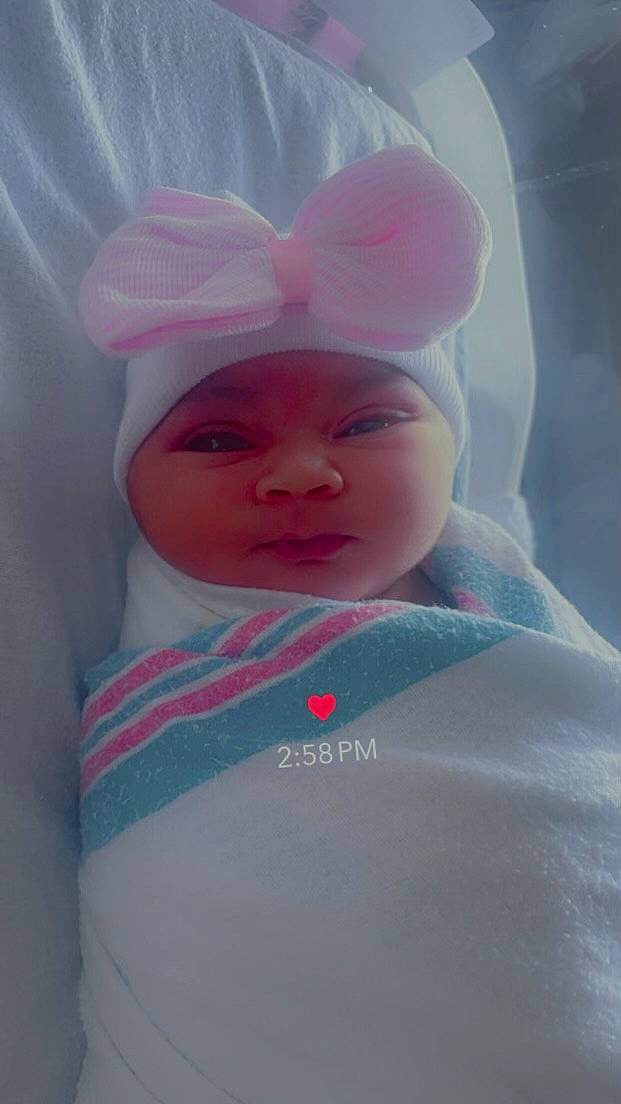 Amila joined the competition — help win amazing prizes! baby, baby_toddler_clothing, beanie, cap, cheek, child, comfort, face, fun, happy, headgear, linens, lip, magenta, nose, person, pink, sleeve, smile, t_shirt