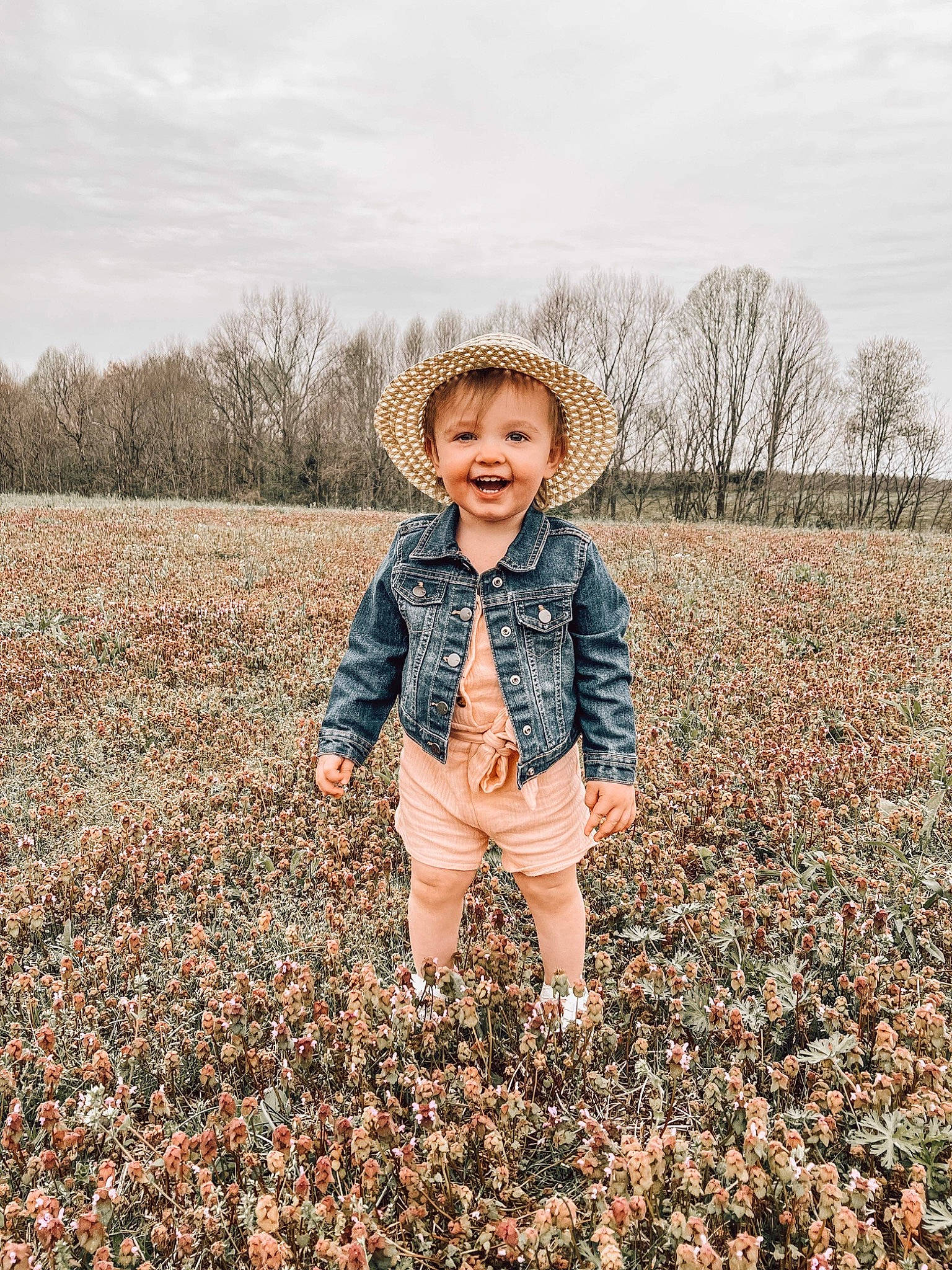 Journi joined the competition — help win amazing prizes! flash_photography, gesture, grass, grassland, happy, jacket, joy, landscape, natural_landscape, people, people_in_nature, person, plant, prairie, sky, smile, soil, standing, toddler, tree