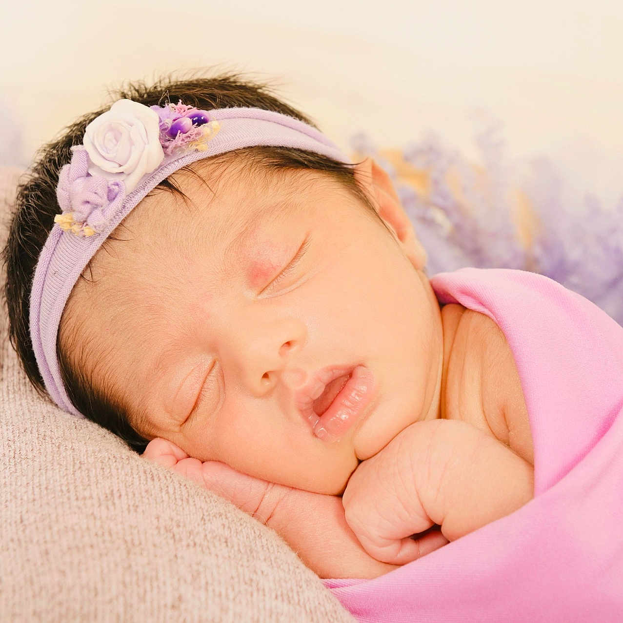 Krithika is registered to the contest to win money with this photo: accessories, baby, blanket, face, flower, happy, head, headband, newborn, person, photography, plant, portrait, purple, rose, sleeping, smile