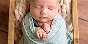 Brynleigh is registered to the contest to win money with this photo: baby, basket, blanket, crib, face, furniture, hardwood, head, infantbed, newborn, person, photography, portrait, sleeping, wood