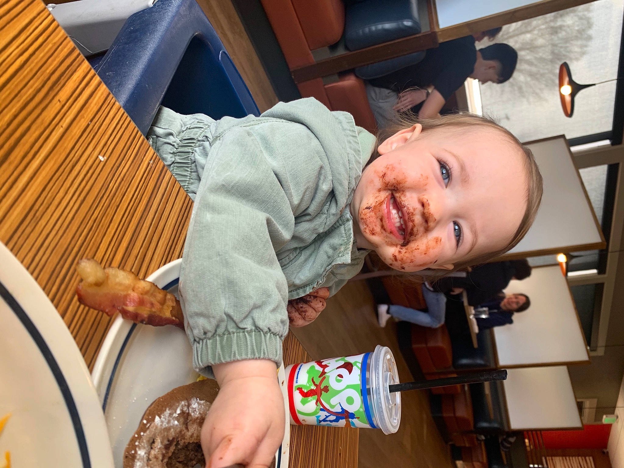 Lizzie is registered to the contest to win money with this photo: baby, baby_products, baby_toddler_clothing, blurred, chair, child, comfort, finger, fun, happy, laugh, person, room, sitting, smile, t_shirt, thigh, toddler