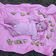 Kaÿla is registered to the contest to win money with this photo: baby, infant, pink_blanket, grass, green_apples, circle, onesie, sweet_and_sassy, outdoor, cute, face, lying_down, blue_eyes, small_fruit, nature, texture, skin, child, portrait, peaceful