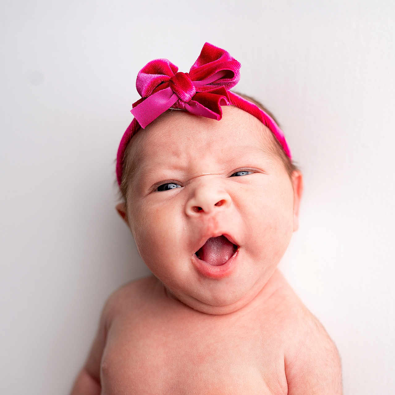 Presleigh Mae is registered to the contest to win money with this photo: baby, child, closeup, cute, expression, face, funny_face, headband, headwear, human, indoor, infant, isolated, people, pink_bow, portrait, skin, studio, white_background, young