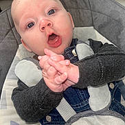 Leeroy participe au concours pour gagner de l'argent avec cette photo : baby, child, clothing, cushion, cute, denim, expression, eyes, face, hands, head, indoor, infant, mouth, person, seat, sitting, skin, straps, young