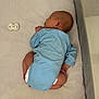 baby, bedtime, blue_onesie, child, cozy, crib, cute, indoors, infant, mattress, newborn, pacifier, peaceful, quiet, resting, side_profile, sleeping, small_hands, soft_texture, toddler