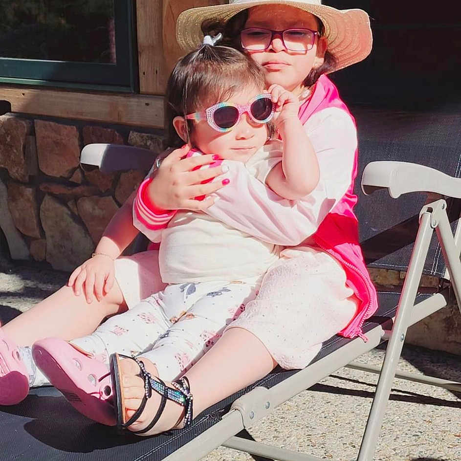 Ashley Ortyz joined the competition — help win amazing prizes! accessories, baby, baseballcap, cap, clothing, face, footwear, furniture, glasses, hat, head, person, photography, portrait, sandal, shoe, shorts, sitting, summer, sunglasses