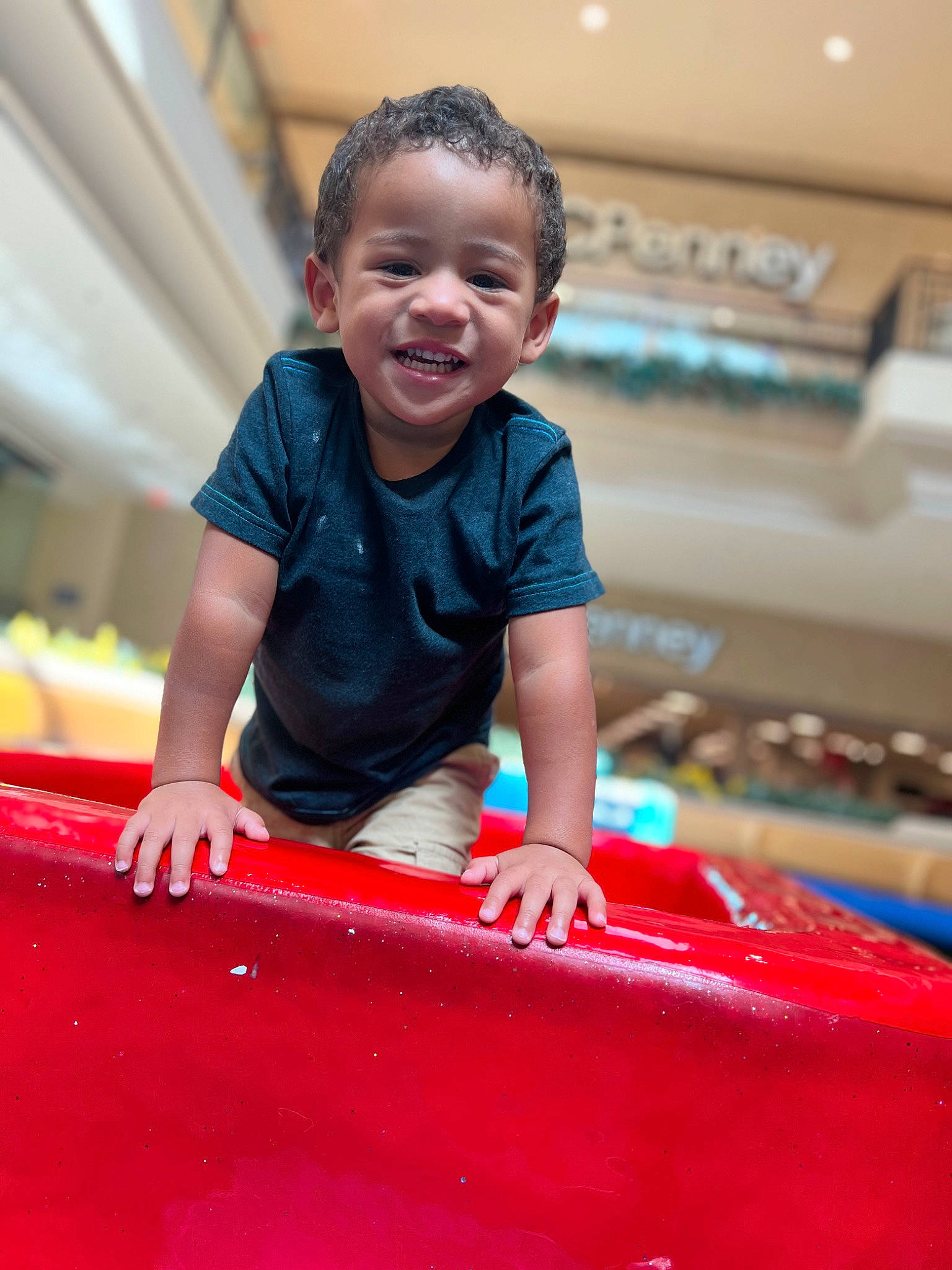 Eli is registered to the contest to win money with this photo: automotive_design, automotive_exterior, automotive_tire, bumper, carmine, child, fun, grass, happy, hood, joy, leisure, magenta, motor_vehicle, person, recreation, sitting, sleeve, smile, t_shirt