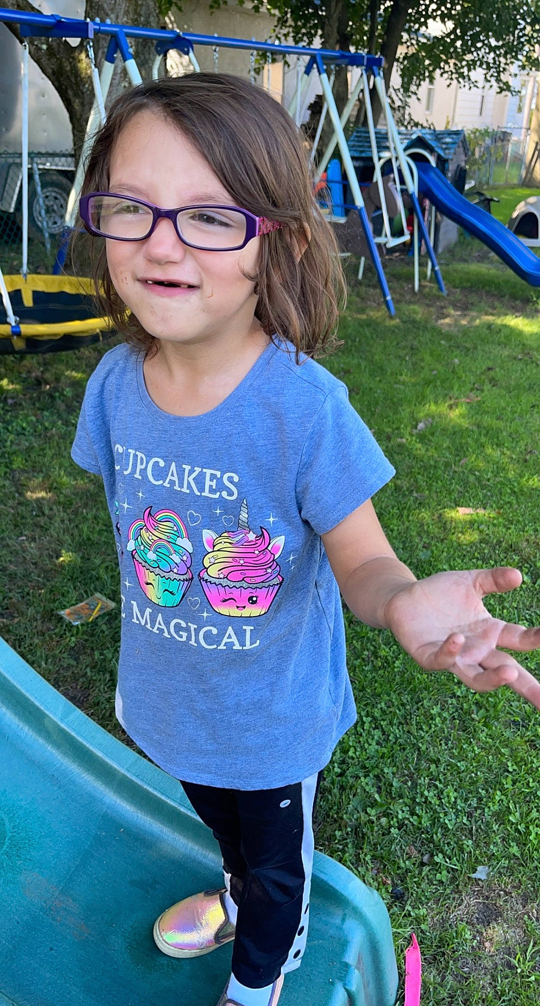 Gabriella is registered to the contest to win money with this photo: blue, chair, child, cool, electric_blue, eyewear, fun, glasses, grass, hairstyle, happy, joy, leisure, person, public_space, recreation, sleeve, smile, snapshot, sportswear