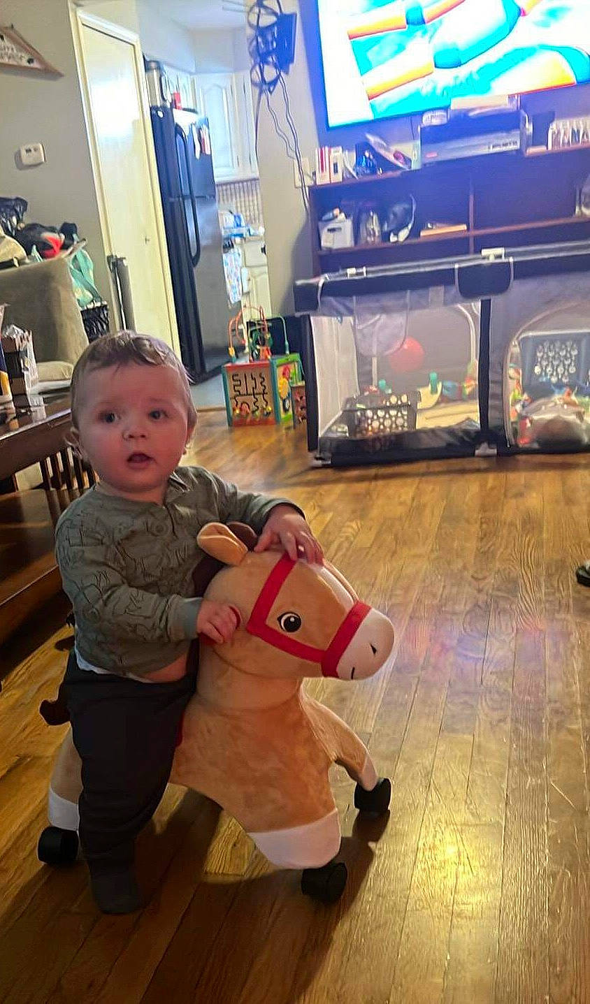 Phenix is registered to the contest to win money with this photo: baby, baby_toddler_clothing, bag, child, display_device, floor, flooring, fun, happy, leisure, luggage_and_bags, metal, person, play, recreation, room, snapshot, surprise, t_shirt, toddler