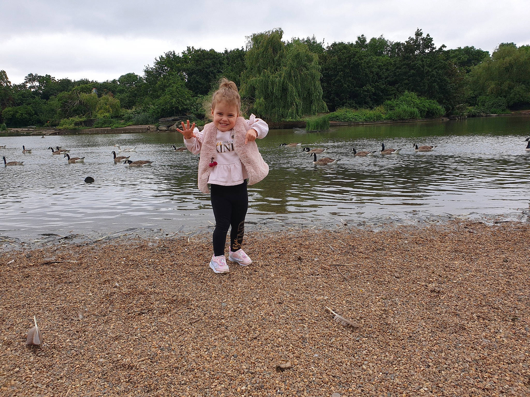 Alexia is registered to the contest to win money with this photo: bank, cloud, fun, grass, happy, joy, lake, landscape, leisure, natural_landscape, nature, people_in_nature, person, plant, recreation, reservoir, shore, sky, toddler, tree