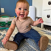 Colton joined the competition — help win amazing prizes! baby, child, smiling, jeans, shirt, shoe, carpet, indoor, happy, person, floor, furniture, drawer, toy, playroom, blue, beige, skin, hand, footwear