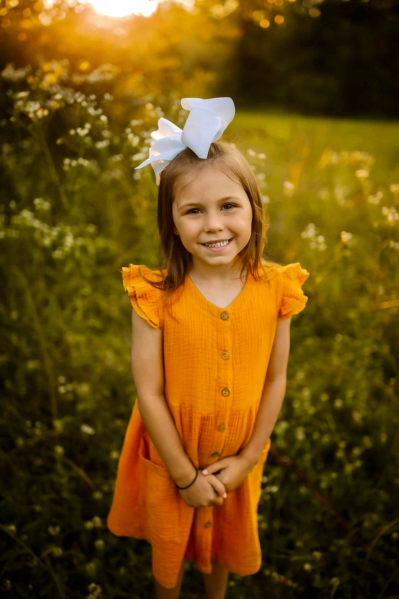 Kinley is registered to the contest to win money with this photo: child, dress, eye, flash_photography, flower, grass, grassland, happy, head, joy, leaf, light, meadow, people_in_nature, person, plant, smile, standing, summer, sunlight
