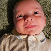 Zayne joined the competition — help win amazing prizes! baby, infant, smile, face, eyes, collared_shirt, clothing, texture, fabric, portrait, cute, child, young, apparel, button, laying_down, human, skin, indoors, expression