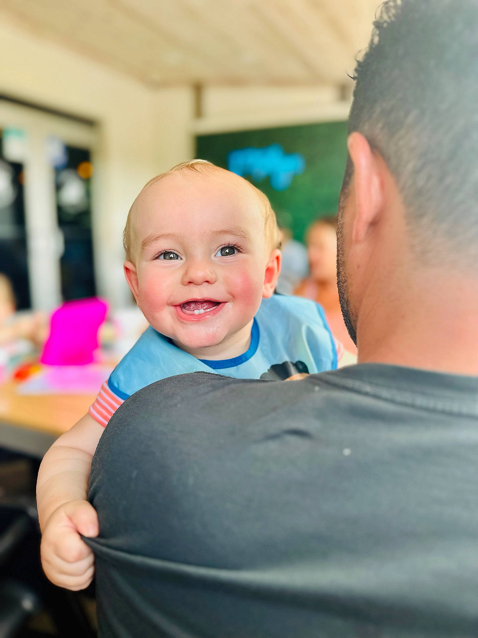 Soren is registered to the contest to win money with this photo: baby, ceremony, chair, child, electric_blue, event, fun, gesture, happy, joy, laugh, leisure, person, recreation, sitting, smile, t_shirt, toddler, vacation