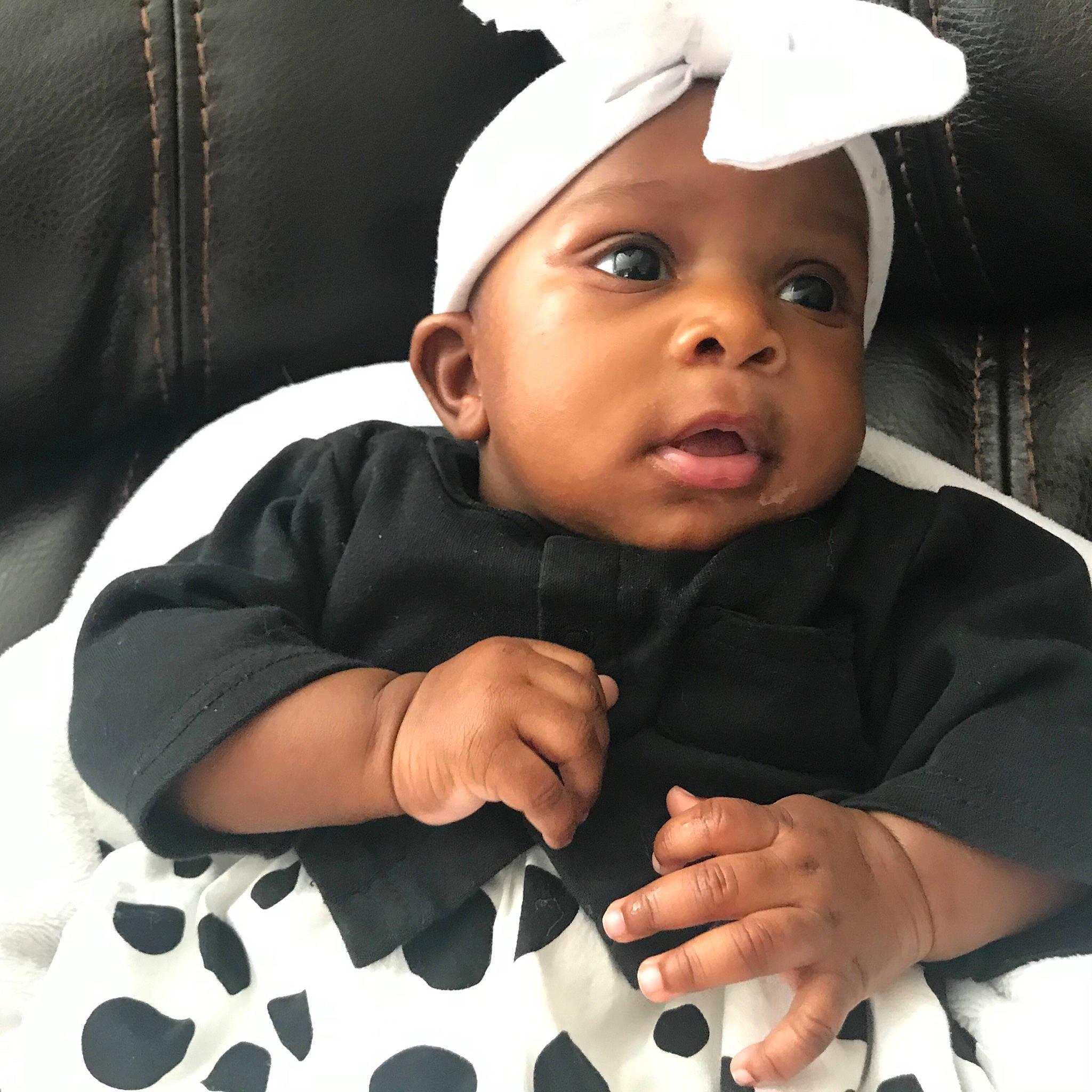 Nia is registered to the contest to win money with this photo: baby, cheek, child, cool, finger, gesture, head, headgear, headwear, person, photography, smile, toddler