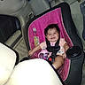 Abigail joined the competition — help win amazing prizes! baby, baby_bottle, car, car_seat, child, child_seat, clothing, cute, happy, headrest, indoor, infant, person, pink, safety, seat, seatbelt, sippy_cup, smile, vehicle_interior