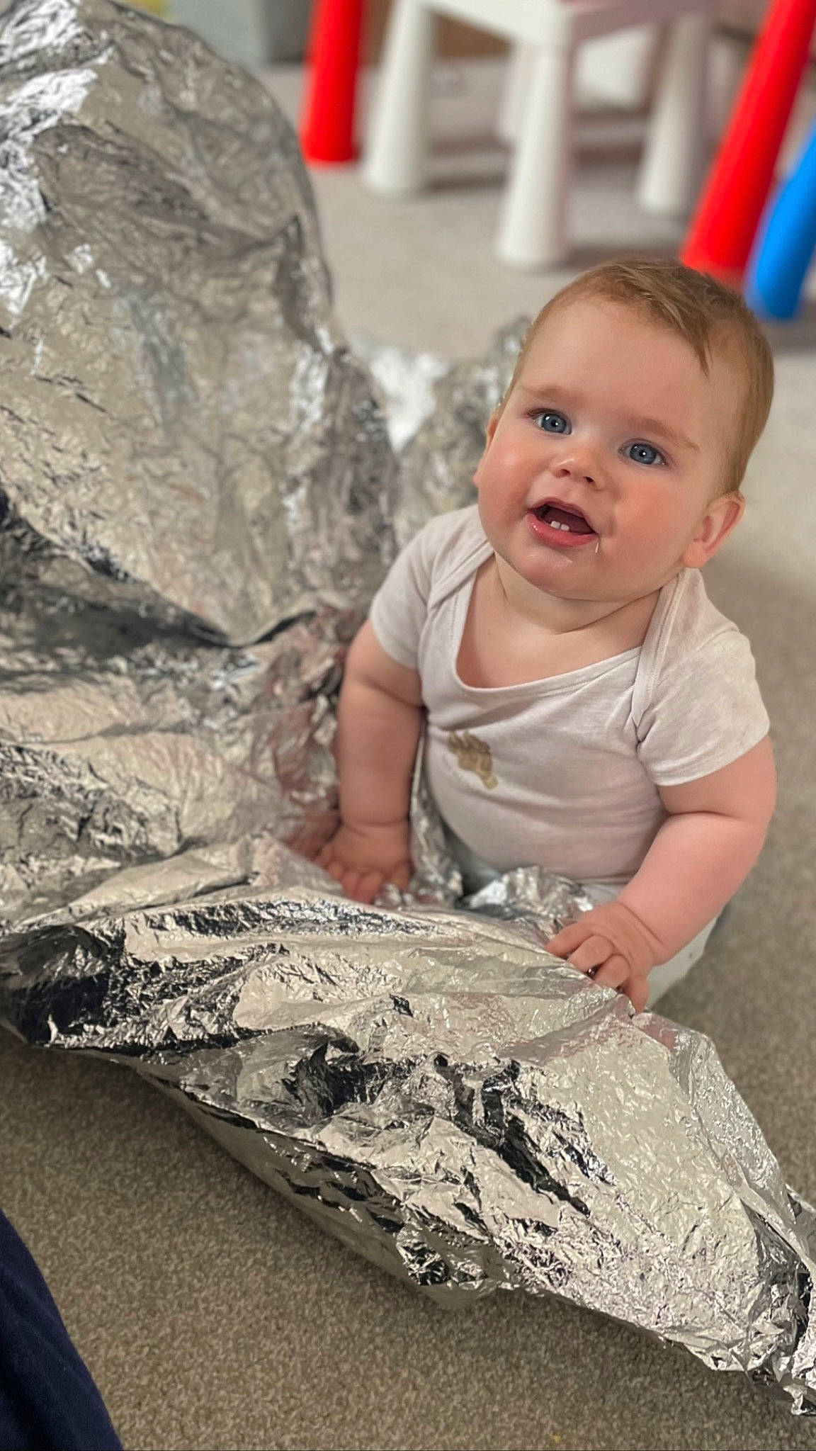 Louis is registered to the contest to win money with this photo: asphalt, baby, eye, facial_expression, flooring, fun, grass, hairstyle, happy, iris, person, recreation, road_surface, sand, sitting, smile, soil, standing, t_shirt, toddler