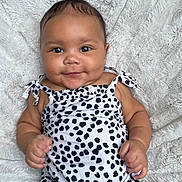 Kalani joined the competition — help win amazing prizes! arms, baby, blanket, child, cute, face, happy, indoors, infant, legs, lying_down, onesie, patterned_clothing, person, portrait, skin, smiling, soft_texture, toddler, young