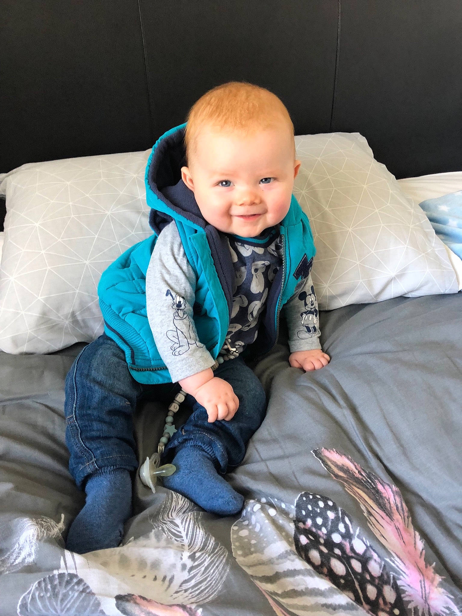 Cian is registered to the contest to win money with this photo: blue, child, eye, fun, infant, joy, outerwear, person, product, sitting, skin, smile, textile, toddler