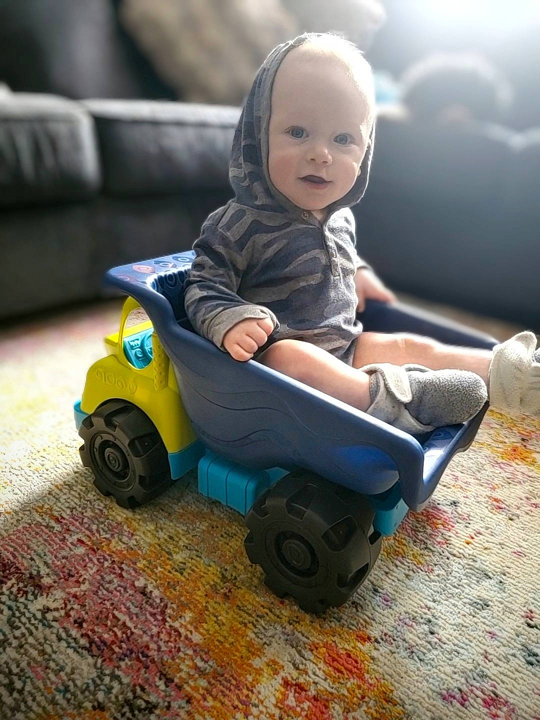 Malachi joined the competition — help win amazing prizes! automotive_design, automotive_tire, automotive_wheel_system, baby, child, flash_photography, flooring, grass, happy, model_car, motor_vehicle, person, riding_toy, rolling, sitting, tire, toddler, toy, vehicle, wheel